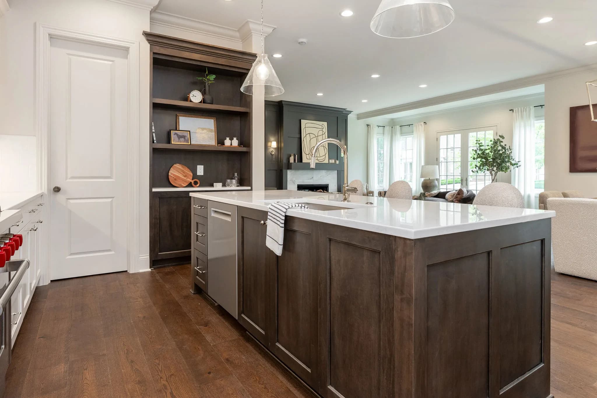 The kitchen of 115 Keswick — island seating, quartz counters, custom hood